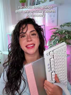 A woman with long dark hair smiles, holding a tablet and a keyboard in front of a bright background. Text overlays the top that reads "random tech things that are actually worth the money."