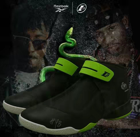 An image featuring a dark, stylized design with a pair of black and green sneakers as the central focus. The sneakers are high-top, with a sleek, modern design and a bright green strap across the top. In the background, there are blurred images of two men. The background features the Reebok logo. A green snake winds around the sneakers, adding a dynamic visual element. Signature tags enhance the exclusivity.