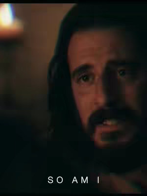 The cover image shows a close-up of a man's face with a beard, dark hair, wearing a hooded garment, and a text overlay that reads, "SO AM I". The image has a moody, low-light atmosphere with the man looking directly at the viewer.