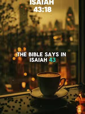 An indoor shot focuses on a coffee cup and saucer placed on a table near a window. The background shows a blurry cityscape, with lights that suggest an evening or nighttime setting. Overlayed text in a white font is added at the top and bottom, emphasizing the Bible verse.