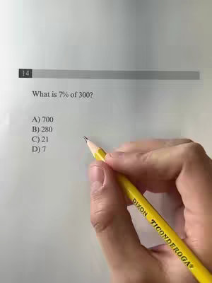 A hand holding a yellow pencil is poised over a math problem printed on paper. The top of the paper shows a horizontal grey bar with the number 14 in a small black box on the left. The math problem is a word problem asking 'What is 7% of 300?'. Below the question are four multiple-choice answers. The pencil is resting in front of the potential answers.