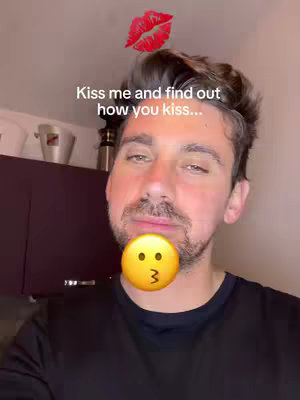 A selfie-style image featuring a man looking at the viewer with a kissy-face emoji over his mouth. Above his head is a red lipstick kiss mark graphic, and superimposed over it is some text.