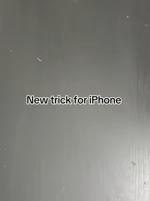 A gray, slightly textured background with the text 'New trick for iPhone' in the center.