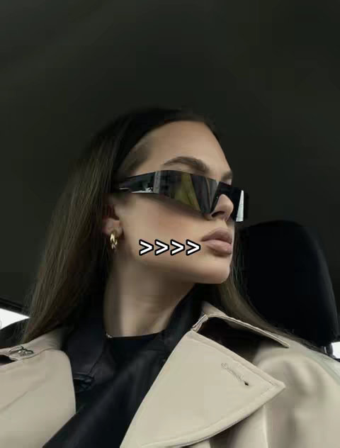 A woman with long brown hair wearing large black sunglasses and a light-colored coat looks to the right. Arrows are overlaid on the image.