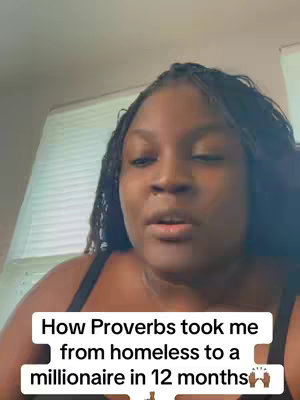 A woman with dark skin and long braids is centered in a selfie-style video. Text overlayed on the lower portion of the video advertises the video's content. The background depicts part of a window and blinds.