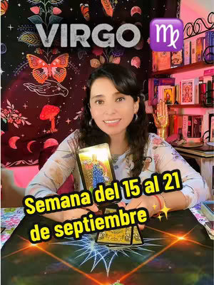 The cover image features a woman in a light floral top seated at a table. She is smiling at the camera and holding a tarot card, specifically The Empress card, upright. The background includes a wall decorated with a celestial tapestry featuring a butterfly. A sign reading "VIRGO" is at the top. Text overlay reads "Semana del 15 al 21 de septiembre" in bold, yellow font. The sign of Virgo is also present. Additional objects are visible on bookshelves in the backdrop. The lighting appears soft and natural.