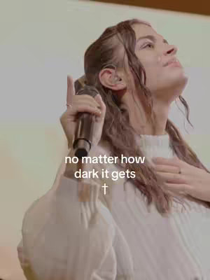 The cover image features a woman holding a microphone and looking upwards with a hopeful expression. She is wearing a white top, and the background is a soft, light color. The composition is a close-up shot, focusing on her face and upper body.