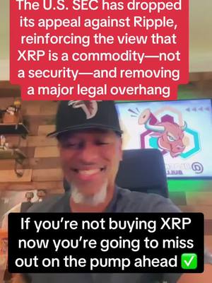 The cover image features a man in a black cap smiling in front of a screen displaying an image of a bull. Text overlays highlight news about XRP.