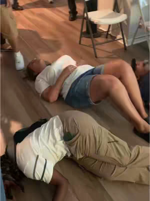 The cover image shows an indoor scene with several people on the floor, presumably in a state of religious practice or emotional expression. The composition is from a slightly elevated angle, with the focus on two individuals lying down on a wooden floor. The person in the foreground is lying face down, while the person in the background is lying on their back with their eyes closed and arms resting at their sides. Other people are standing around. The lighting appears to be natural.