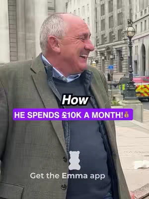 A man in a blazer and dark shirt smiles broadly while standing outside. Text overlays state, "How HE SPENDS £10K A MONTH!" in white and a purple rectangle with a money bag emoji. The "Emma" app logo is in white at the bottom.