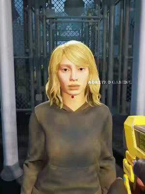 The image shows a woman with blonde hair, wearing a dark hoodie, standing in front of what appears to be a metal cage, with text overlay. The background is a bit blurred, focusing attention on the woman. A yellow object is partially visible on the right.