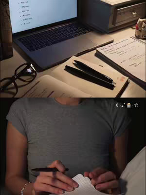 The cover image is split into two sections, with study essentials in the top half and a person in the bottom half with a notebook. In the upper portion, a laptop displaying a screen with foreign language characters, along with glasses, pens, and open notebooks are on a desk lit by warm lighting. In the bottom portion, only the lower half of a person is visible, sitting in bed with a gray shirt, appearing to be writing on a notepad in their hands. The background is dimly lit.