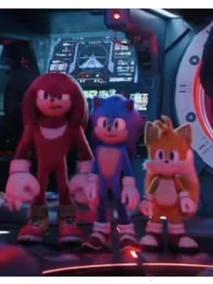 The cover image features three animated characters from the Sonic the Hedgehog franchise. From left to right, the characters are Knuckles the Echidna, Sonic the Hedgehog, and Tails. They are standing in what appears to be a control room or spaceship interior. The background includes various screens and panels with technical displays. The characters are positioned as if they are in a scene within the movie. The overall composition uses a dark color palette with bright highlights on the characters.