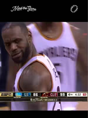 The image shows a close-up of basketball player LeBron James looking down and slightly to the left, with a determined expression on his face. He is wearing a white and gold basketball jersey, and a blurred figure is visible in the background. At the bottom of the frame, a sports statistics bar displays the score and game clock.