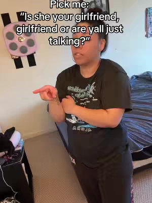 The cover image features a woman indoors, posing for the camera while pointing to her left. She is wearing a black t-shirt and black pants. White text is overlaid at the top left corner of the image.