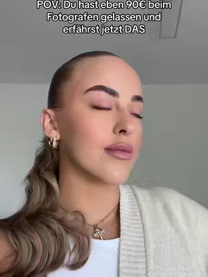 A person is shown in a close-up shot, centered in the frame, with eyes closed and a slight upward tilt of the head. The person has light skin, smooth features, and is wearing a white top under a beige cardigan. Her hair is pulled back, with a low ponytail. The background is plain, emphasizing the person's face and upper body. The hook text is displayed at the top, and there's visible jewelry.