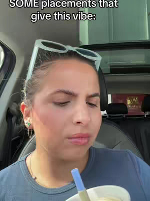 The cover image features a close-up of a woman inside a car. She's looking slightly upward with a contemplative expression. She wears a blue shirt, has a fair complexion, and light-colored sunglasses perched on her head. The text overlay identifies the video as pertaining to astrology.
