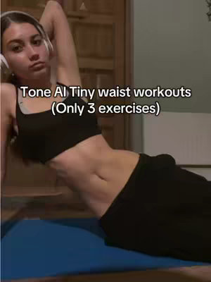 A woman is lying on a yoga mat, with her upper body raised, head resting on her arm. She is wearing a black sports bra and black pants. Text overlay indicates the video is about Tone AI Tiny Waist workouts.