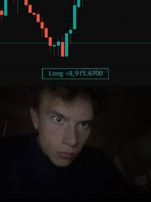 The cover image shows a young man with wide eyes, looking shocked or surprised. Backgrounded above is a chart showing a downward trending stock graph, along with a Long $8,915.6700 label. The layout combines financial data with personal reaction, set against a dark background.