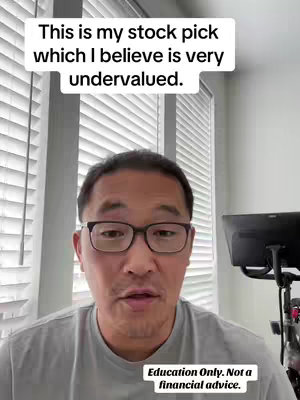 A man with glasses is centered in the frame, set against an environment with closed blinds. Above him is a text overlay. At the lower left of the frame is another smaller, rectangular text box.