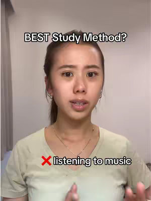 A medium shot displays an Asian woman in a light green shirt, looking straight at the camera. Overlayed on the image is the text "BEST Study Method?" above the subject's head, and a red X symbol next to the text "listening to music" on the lower third of the visual. The background is a plain, neutral-colored wall. The woman has her hair pulled back, with small hoop earrings in place. The lighting appears to be natural. The overall composition emphasizes a direct message about studying.