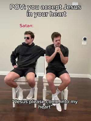 The cover image depicts a skit scene with two men seated on white chairs against a neutral background. The man on the left, wearing sunglasses and a black hoodie, is posed with an arm resting on the chair back, appearing nonchalant. The man on the right, in a black t-shirt, is leaning forward with hands clasped in a prayerful gesture. Text overlays in the image include "POV: you accept Jesus in your heart" and "Satan:" above the figures, with the words "Jesus please come into my heart" at the bottom.