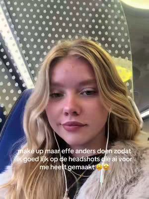 A young woman with long blonde hair is posing in front of a background with white dots on a grey metallic finish, appearing to be inside a car or train. She is wearing earbuds and light-colored fur-like clothing over a black top. The overlaid text in the image mentions making up for headshots created by AI.