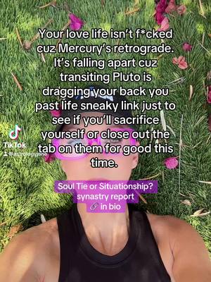 A person is lying on grass, looking up at the camera. They have pink-framed glasses, black tank top and a black hat. Text overlays are placed over them. The background features green grass and some flowers.