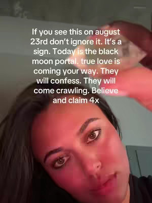 The image shows a close-up of a woman's face, prominently featuring her eyes. Text is overlaid, conveying a message about the black moon portal. The color palette leans towards warmer tones with the lighting adding a slight red hue to her face.