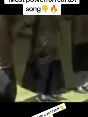 A low-quality image shows a person from the knees down, wearing dark clothing and light-colored shoes. The background appears to be nondescript and poorly lit, suggesting an indoor setting. Overlay text is added at the top and bottom.