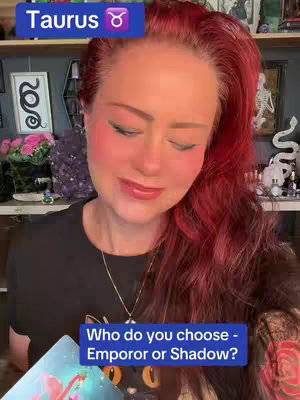 The cover image depicts a woman with long red hair, wearing a black top, and looking down. She has visible makeup, including blush. A blue rectangle with white text that reads 'Taurus' is visible at the top left corner of the frame, and a darker blue rectangle with the text "Who do you choose - Emperor or Shadow?" is at the bottom.