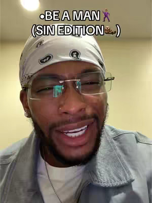 A man with a light skin tone wearing a white bandana, clear glasses, a light blue shirt, and a silver necklace in front of a beige background. The image has overlaid text at the top, emojis. The man is smiling and looking towards the viewer.