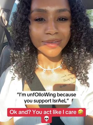 A selfie-style video cover image features a young woman with dark, curly hair and a neutral expression. She has a necklace and a tattoo visible on her chest. Text overlays are present, including a comment and a call to action at the bottom.