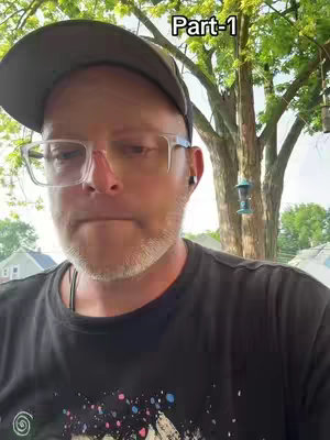 A man is looking at the camera and is wearing a hat and glasses.