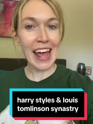 A woman with light-blonde hair is smiling and talking directly to the camera in a selfie-style shot. She's wearing a green t-shirt and the background includes a bed, a small artwork, and a bedside accessory. A rectangle with the text 'harry styles & louis tomlinson synastry' is positioned at the bottom of the image.