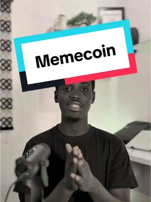 A cover image featuring a young Black man facing the camera, hands clasped. A rectangular overlay reads "Memecoin," with a cyan, red, and white border. The background is a blurred, grayscale setting with a microphone.