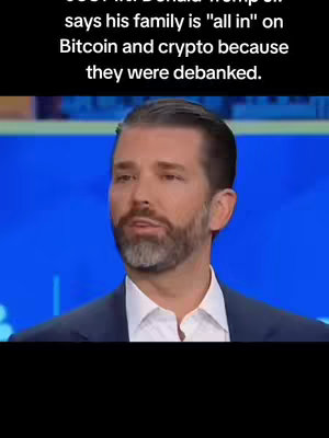 The cover image features Donald Trump Jr. in a close-up shot, against a blurred blue background. Above him, a text overlay states his family's stance on Bitcoin and crypto, linking it to their 'debanked' status. He is dressed in a dark suit, and is facing the camera and speaking, his expression is somewhat serious.