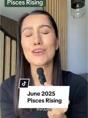 A centered shot of a woman facing the camera and speaking. The overhead text says 'Pisces Rising.' She is holding a microphone. A black rectangular tag with white text that reads 'June 2025 Pisces Rising' is present at the bottom. The background shows a section of wooden paneling.