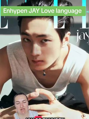 The image features a K-pop star, Enhypen's Jay, from a magazine cover. Overlaid on that is a woman speaking below. The background image is in a magazine setting that includes the word "Elle". JAY's face is centered with a tank top, jewelry, and dark hair. The woman sits at the bottom half of the frame.