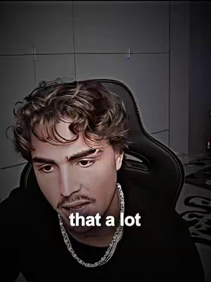 The image showcases a young man looking down thoughtfully, seated in a black chair with a dark background. The man has curly brown hair and is wearing a black shirt and a silver chain necklace. The hook text "that a lot" is overlaid.