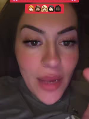 A close-up shot features a woman looking directly at the camera, framed from the chest up. She has brown hair, visible eyebrows, and full lips. A row of five emoji-style faces representing different hair colors and skin tones is positioned above her head. The background is dark, suggesting the image was taken indoors.