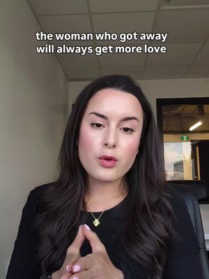A woman with long dark hair is seated, looking directly at the camera. The background suggests an office setting. Above her head, a text overlay reads "the woman who got away will always get more love".