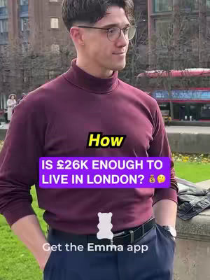 A man in a maroon turtleneck stands in front of foliage and a red bus, with overlaid text asking if £26k is enough to live in London, alongside a call to get the Emma app.