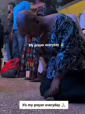 A person kneels on the floor, head bowed in prayer, with others standing around. Text overlays read 'My prayer everyday' and 'it's my prayer everyday'. The scene has a low-angle perspective emphasizing reverence and devotion.