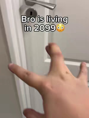 A person's hand outstretched, fingers spread, near a white door with a silver handle and keyhole. Text indicates surprise.