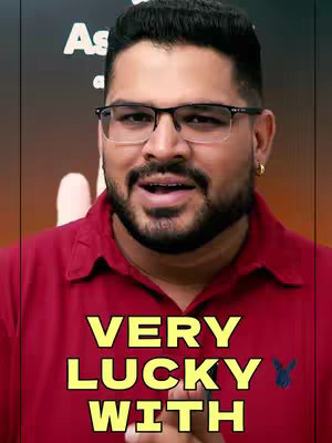 A medium shot features a man with a short beard and glasses, facing the camera. He wears a red polo shirt with a small embroidered logo. The background features text.