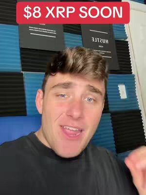 A close-up shot of a young man in a black t-shirt speaking to the camera. The background has a blue and black grid pattern. Above the man's head, a red banner displays the text "$8 XRP SOON."