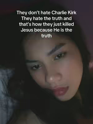 A close-up shot of a woman in a selfie with text overlay. The woman is looking at the camera with a serious expression. The text overlay contains a political opinion.