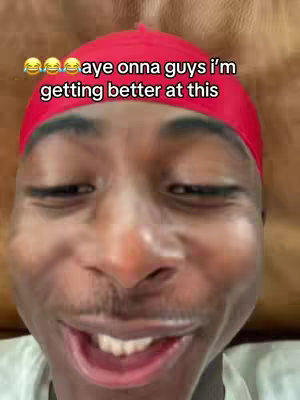 A close-up shot of a Black man with a red durag smiling and slightly squinting, with overlay text above and the top of his face framed in the shot.