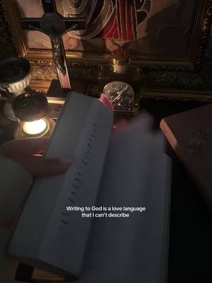 The image is a dark, intimate shot. A hand is holding open a book, possibly a Bible, with text running down the pages. The background is softly lit with candles and religious artifacts like a crucifix. The overall color scheme is dominated by warm tones and shadows. Overlaying the image, text announces the core message.